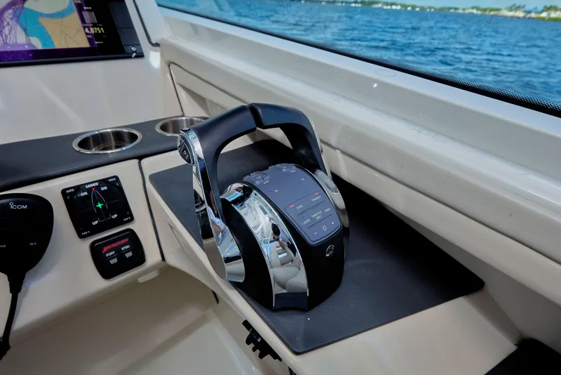 Slide: The Image of Control panel of a 2016 Boston Whaler 320 Vantage boat with throttle levers. - 18