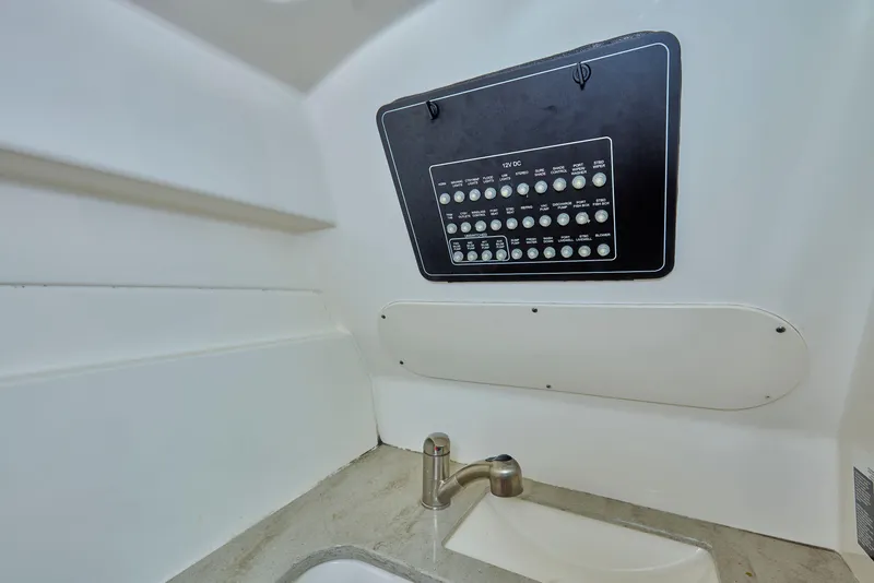 Slide: The Image of Interior of 2016 Boston Whaler 320 Vantage, featuring control panel and sink. - 23