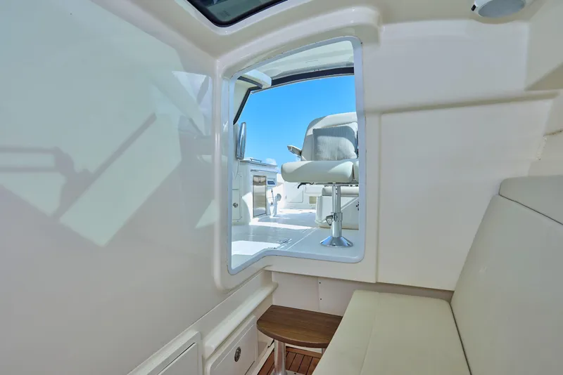 Slide: The Image of Interior view of 2016 Boston Whaler 320 Vantage boat, featuring seating and open hatch. - 25