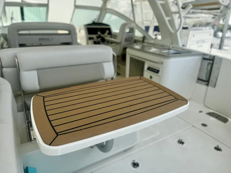 Slide: The Image of 2016 Boston Whaler 320 Vantage interior with seating and table. - 29