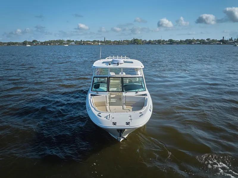 Slide: The Image of 2016 Boston Whaler 320 Vantage boat on open water under blue sky. - 37
