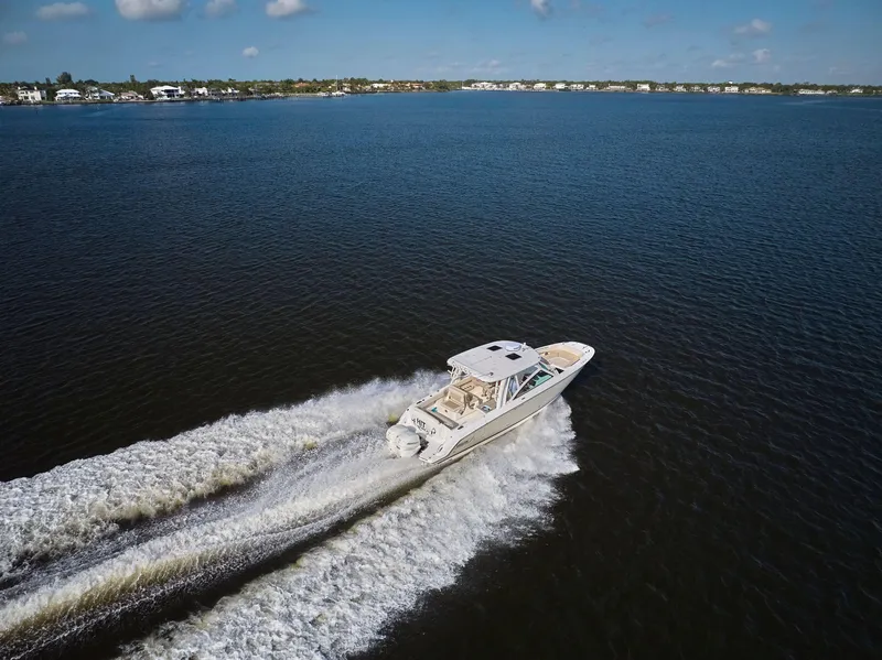 Slide: The Image of 2016 Boston Whaler 320 Vantage cruising on open water, creating a wake. - 40