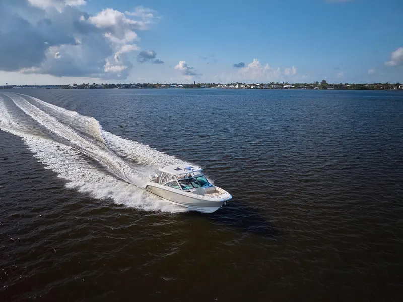 Slide: The Image of Boston Whaler 320 Vantage 2016 cruising on open water under a clear blue sky. - 43