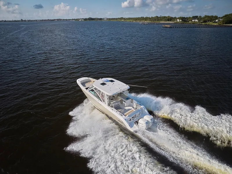 Slide: The Image of 2016 Boston Whaler 320 Vantage cruising on open water, creating a dynamic wake. - 48