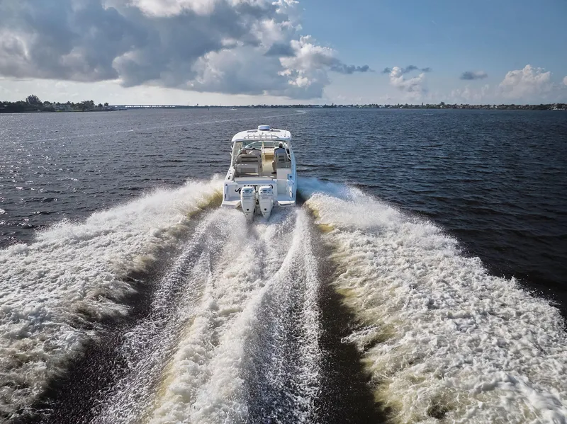 Slide: The Image of 2016 Boston Whaler 320 Vantage cruising on open water, leaving a wake behind. - 49
