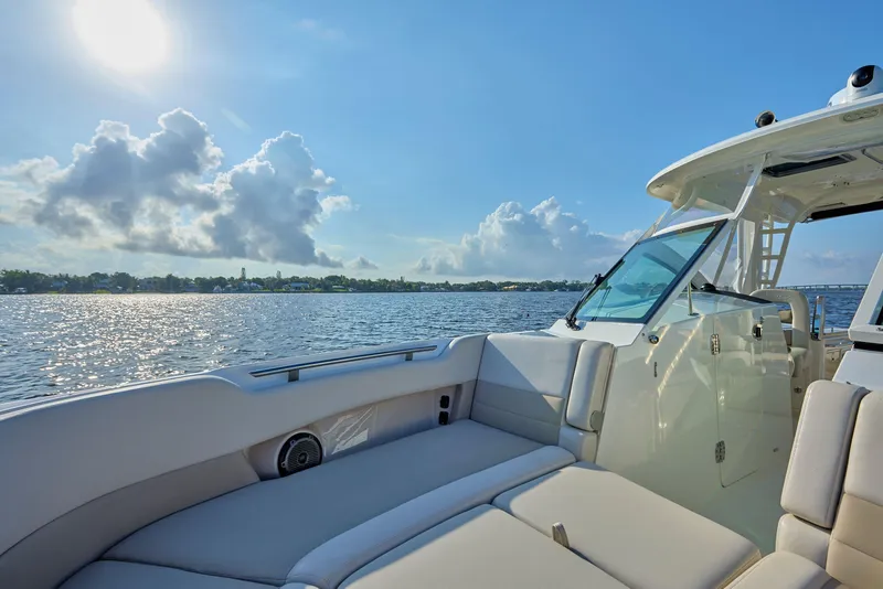 Slide: The Image of 2016 Boston Whaler 320 Vantage boat on calm water under a sunny sky. - 8