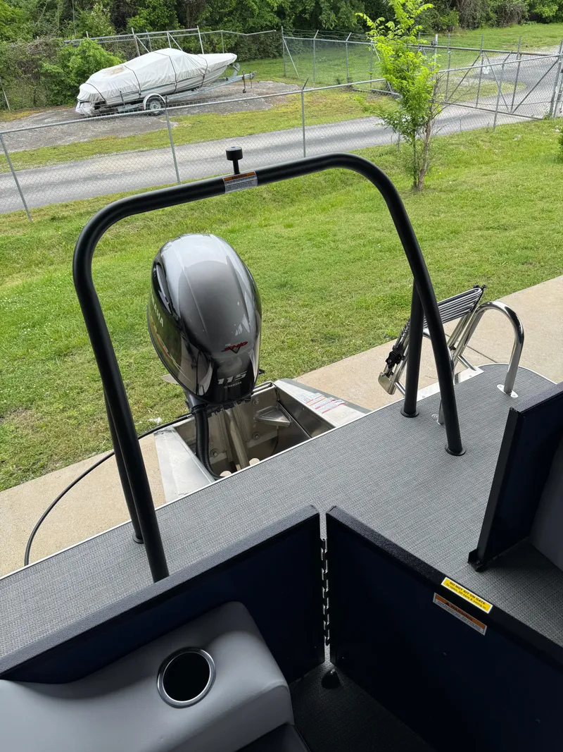 Slide: The Image of 2025 Veranda Vista View 20RC boat with outboard motor, docked on grassy area. - 4