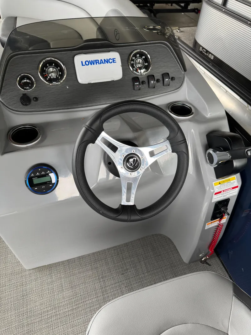 Slide: The Image of 2025 Veranda Vista View 20RC boat dashboard with steering wheel and Lowrance display. - 5