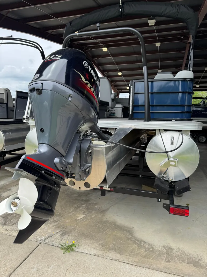 Slide: The Image of 2025 Veranda Vista View 20RC pontoon boat with Yamaha outboard motor, docked under shelter. - 7