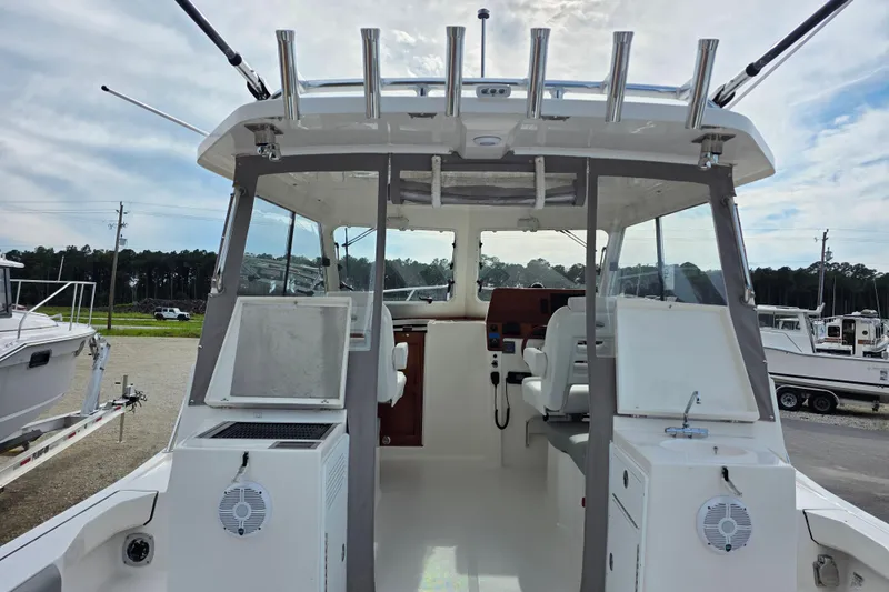 Slide: The Image of 2024 NorthCoast 315 HT boat interior with seating and fishing rod holders. - 10