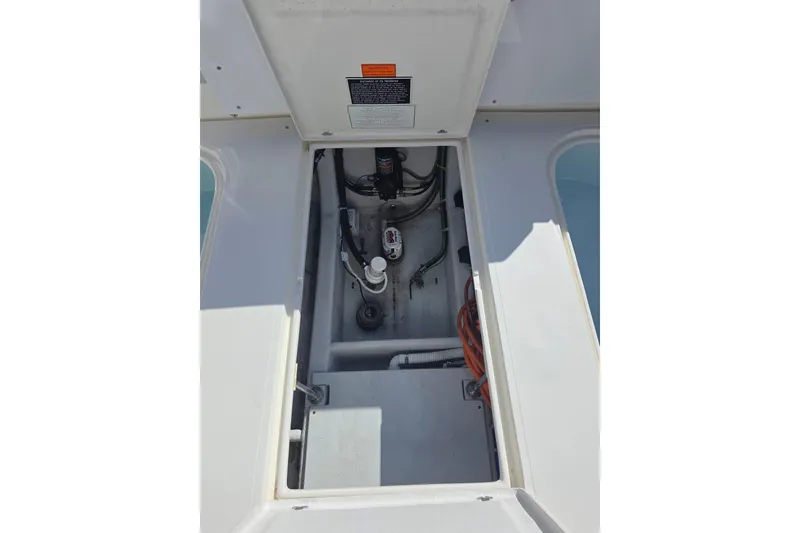 Slide: The Image of 2024 NorthCoast 315 HT boat compartment with visible wiring and components. - 14
