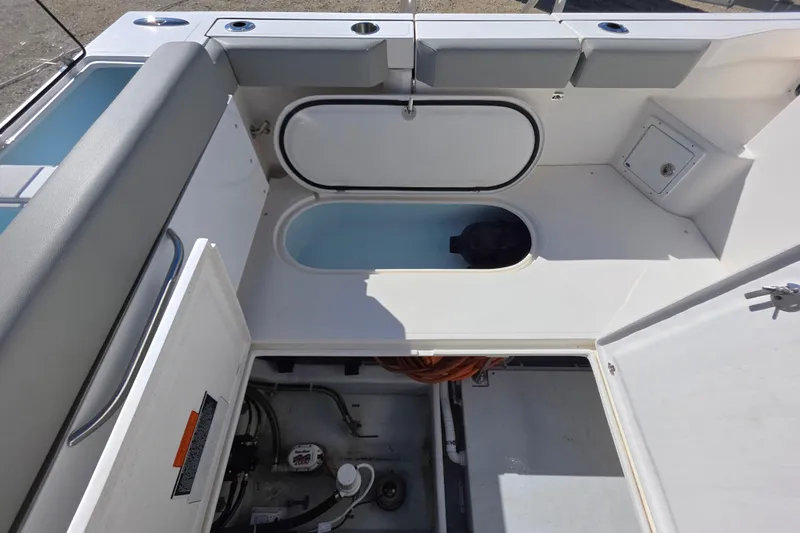 Slide: The Image of 2024 NorthCoast 315 HT boat interior showing storage compartments and seating area. - 15