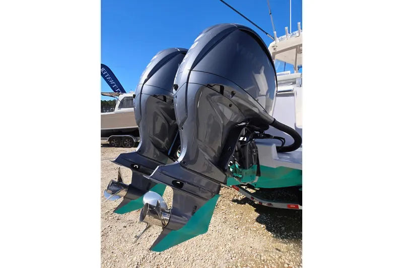 Slide: The Image of 2024 NorthCoast 315 HT boat with dual outboard engines, displayed outdoors. - 28