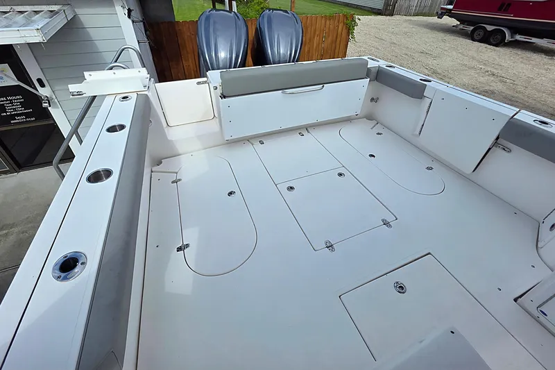 Slide: The Image of 2024 NorthCoast 315 HT boat deck with storage compartments and rod holders. - 3