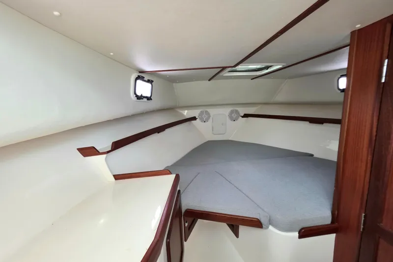 Slide: The Image of 2024 NorthCoast 315 HT cabin interior with cozy sleeping area and wooden accents. - 5
