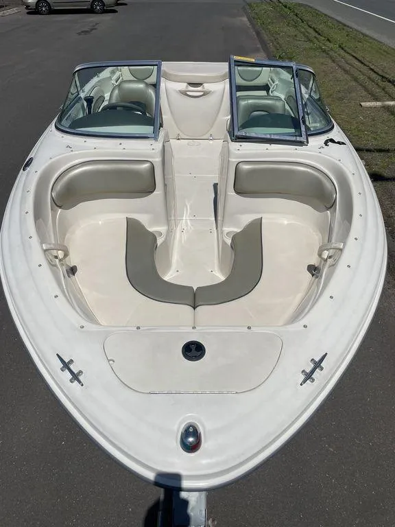 Slide: The Image of 2004 Sea Ray 185 Sport boat with open bow seating and dual windshields. - 13