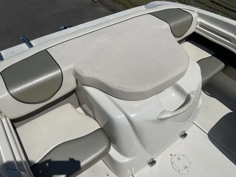 Slide: The Image of 2004 Sea Ray 185 Sport boat interior with cushioned seating and storage. - 3