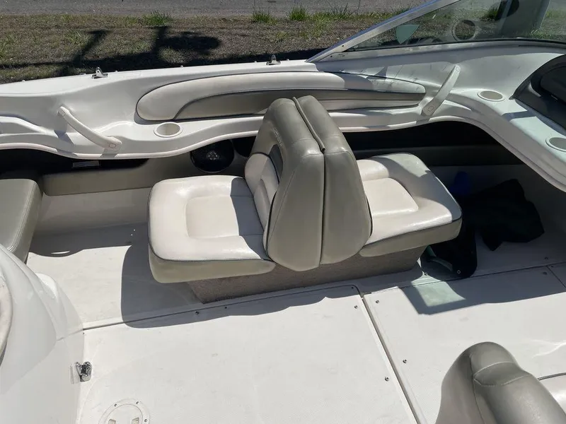 Slide: The Image of 2004 Sea Ray 185 Sport boat interior with white and gray seating. - 4