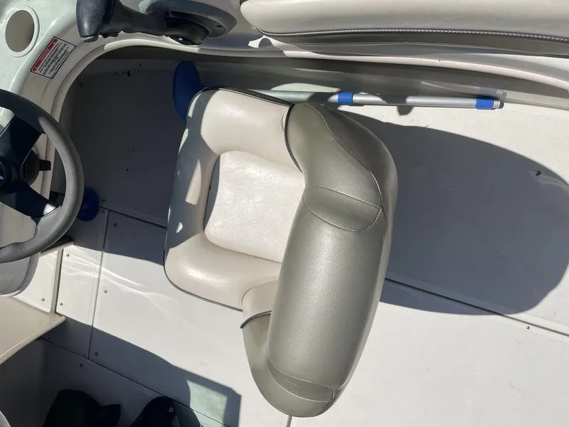 Slide: The Image of 2004 Sea Ray 185 Sport boat interior with steering wheel and seat. - 5