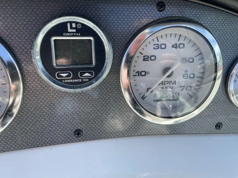 Slide: The Image of Dashboard of a 2004 Sea Ray 185 Sport boat with depth gauge and RPM meter. - 6