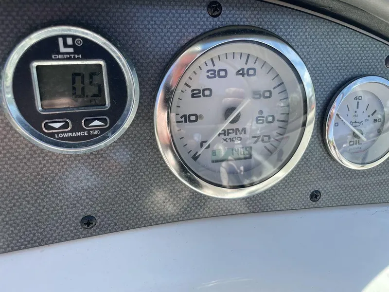 Slide: The Image of Dashboard of a 2004 Sea Ray 185 Sport boat showing depth and RPM gauges. - 7