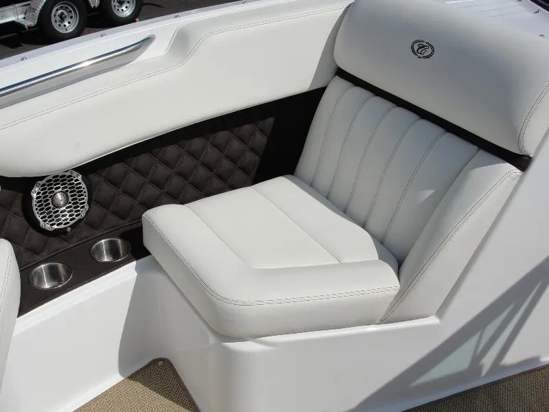 Slide: The Image of 2013 Cobalt A25 boat interior with white leather seating and cup holders. - 10