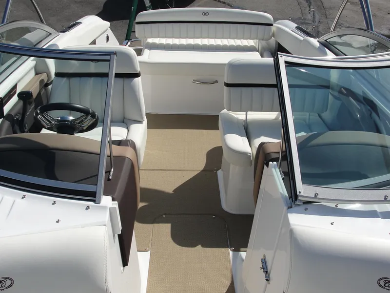 Slide: The Image of 2013 Cobalt A25 boat interior with white seating and beige flooring. - 11