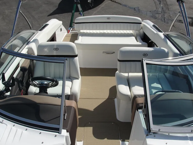 Slide: The Image of 2013 Cobalt A25 boat interior with white seating and steering wheel. - 12
