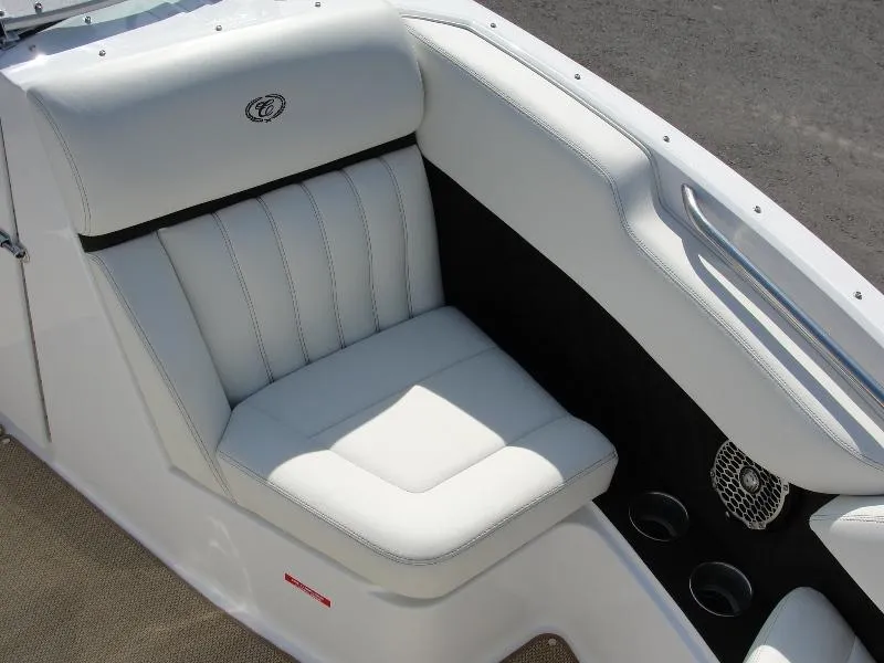 Slide: The Image of 2013 Cobalt A25 boat interior with white leather seating and cup holders. - 13