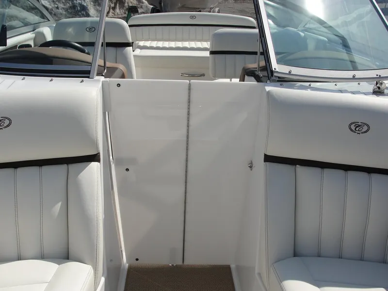 Slide: The Image of Interior view of a 2013 Cobalt A25 boat with white leather seating. - 14