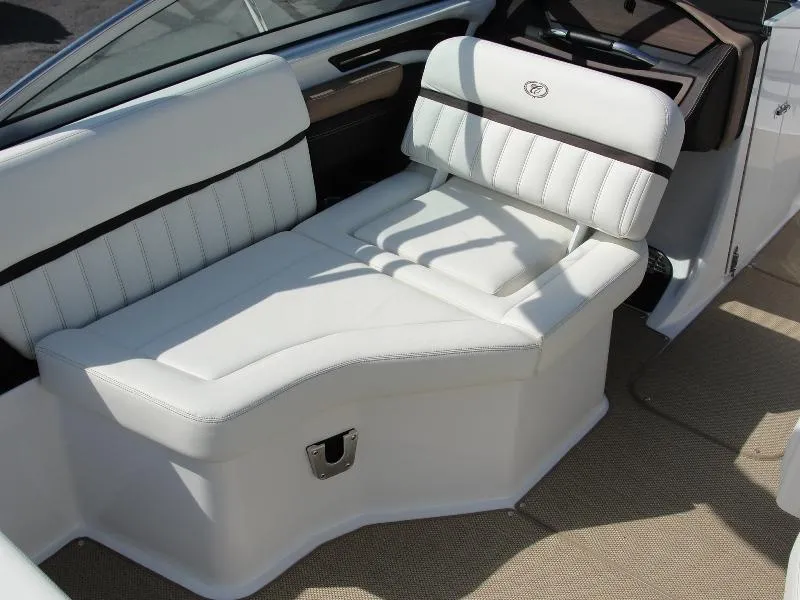 Slide: The Image of 2013 Cobalt A25 boat interior with white leather seating and beige carpet. - 16