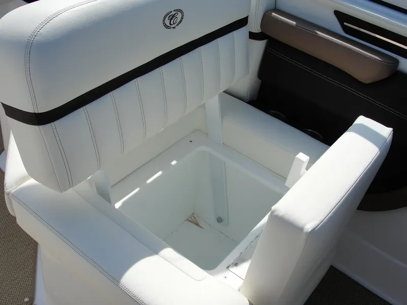 Slide: The Image of White cushioned seat with storage compartment on 2013 Cobalt A25 boat. - 17