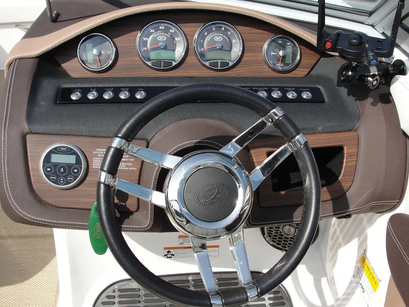 Slide: The Image of Steering wheel and dashboard of 2013 Cobalt A25 boat with gauges and controls. - 21