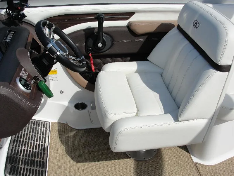 Slide: The Image of Captain's seat and helm of 2013 Cobalt A25 boat, featuring white upholstery and modern controls. - 22