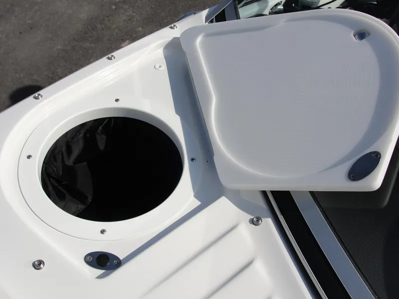 Slide: The Image of 2013 Cobalt A25 boat storage compartment with open lid, showcasing sleek design. - 23