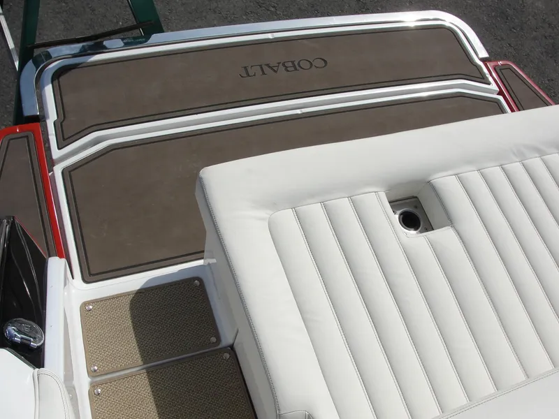 Slide: The Image of 2013 Cobalt A25 boat deck with cushioned seating and non-slip flooring. - 27
