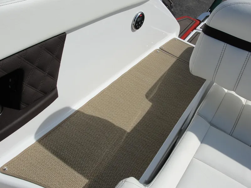 Slide: The Image of 2013 Cobalt A25 boat interior with beige carpet and white seating. - 29