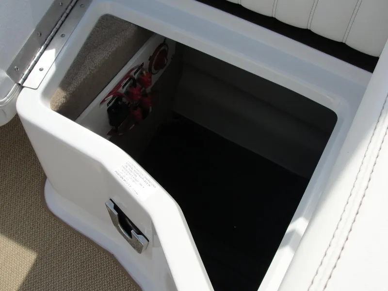 Slide: The Image of Storage compartment in a 2013 Cobalt A25 boat, featuring a white interior. - 30