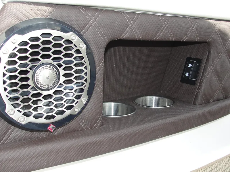 Slide: The Image of 2013 Cobalt A25 boat interior with speaker, cup holders, and control panel. - 33