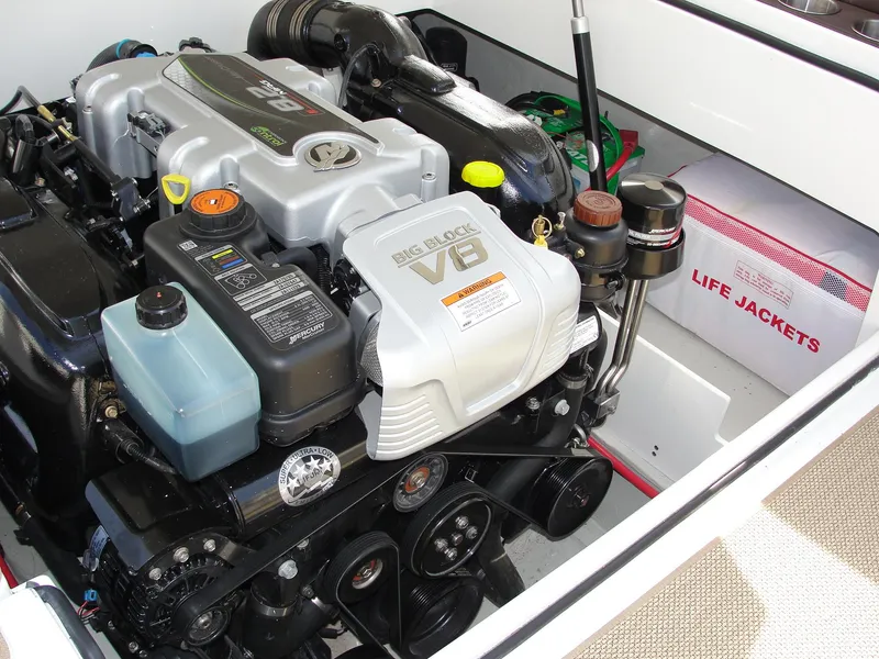 Slide: The Image of Engine compartment of a 2013 Cobalt A25 boat with V8 engine and life jackets. - 34