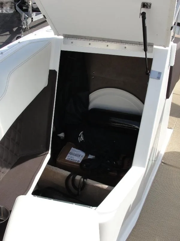 Slide: The Image of 2013 Cobalt A25 boat storage compartment with open hatch, revealing interior space. - 39