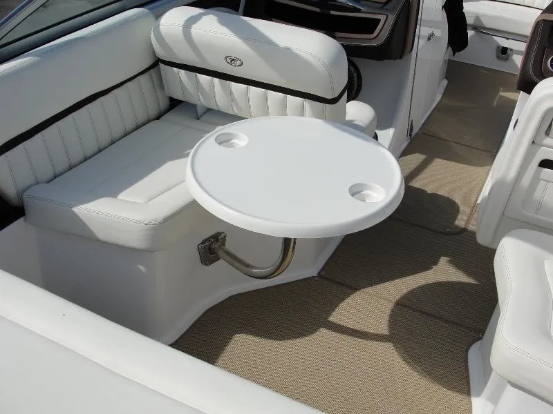 Slide: The Image of 2013 Cobalt A25 boat interior with white seating and a round table. - 40