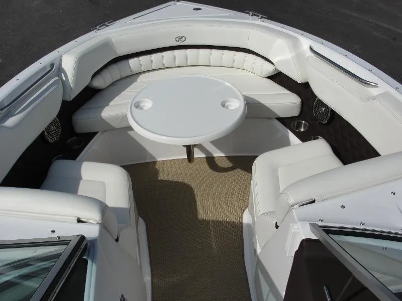 Slide: The Image of 2013 Cobalt A25 boat interior with white seating and round table. - 42