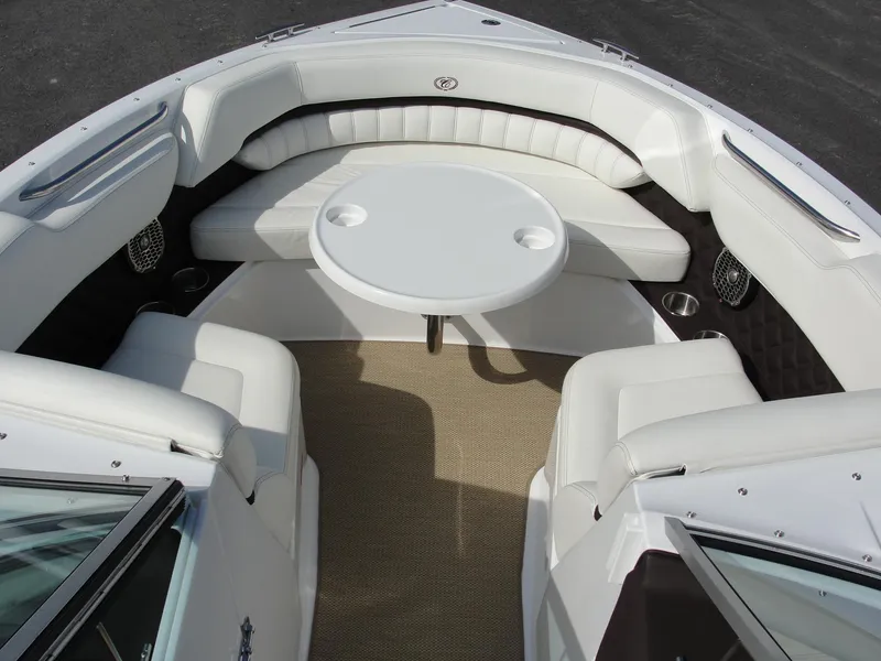 Slide: The Image of 2013 Cobalt A25 boat interior with white seating and round table. - 43