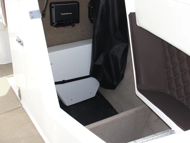 Slide: The Image of Interior storage compartment of a 2013 Cobalt A25 boat, featuring a Rockford Fosgate audio system. - 47