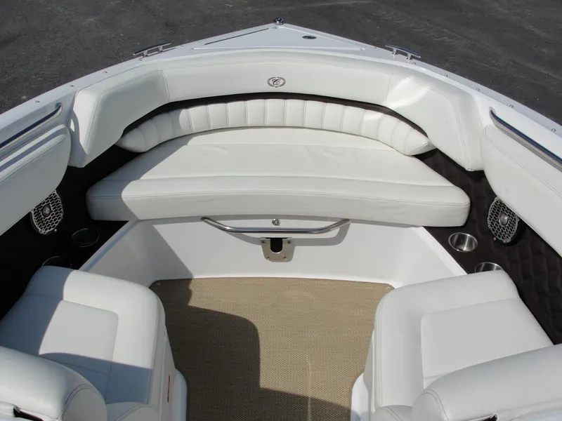 Slide: The Image of 2013 Cobalt A25 boat interior with white leather seating and beige carpet. - 9