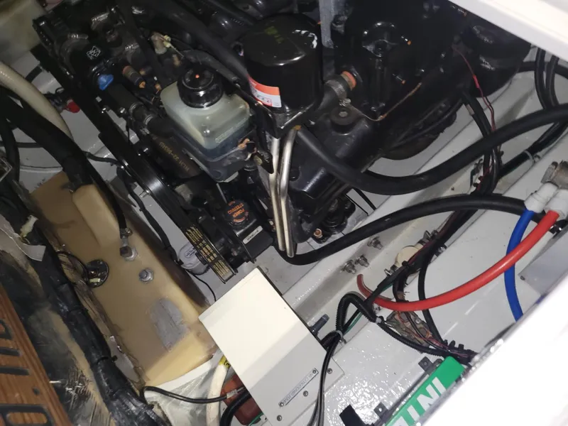 Slide: The Image of Engine compartment of a 2003 Four Winns 248 Vista boat, showing mechanical components and wiring. - 13