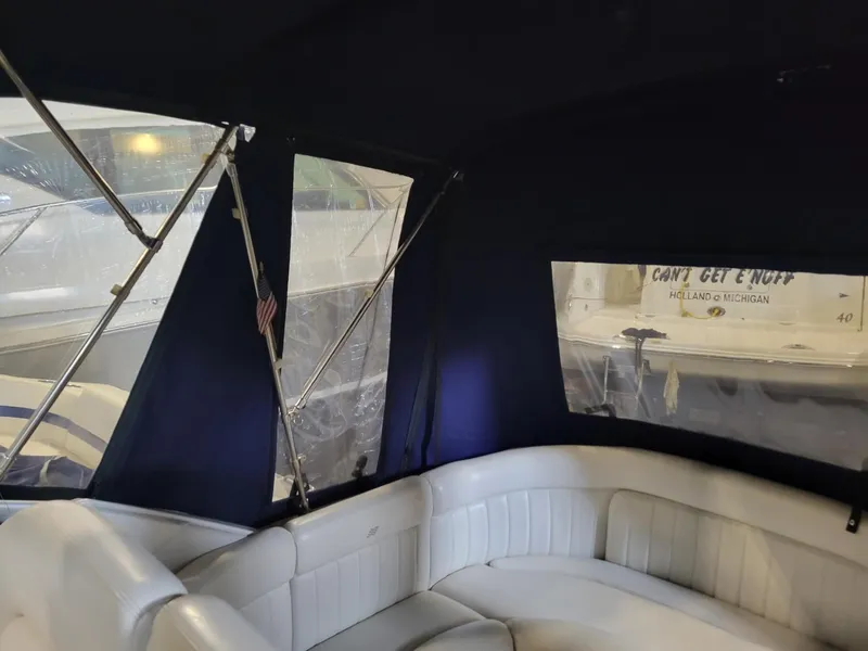 Slide: The Image of Interior view of 2003 Four Winns 248 Vista boat with white seating and dark canopy. - 14