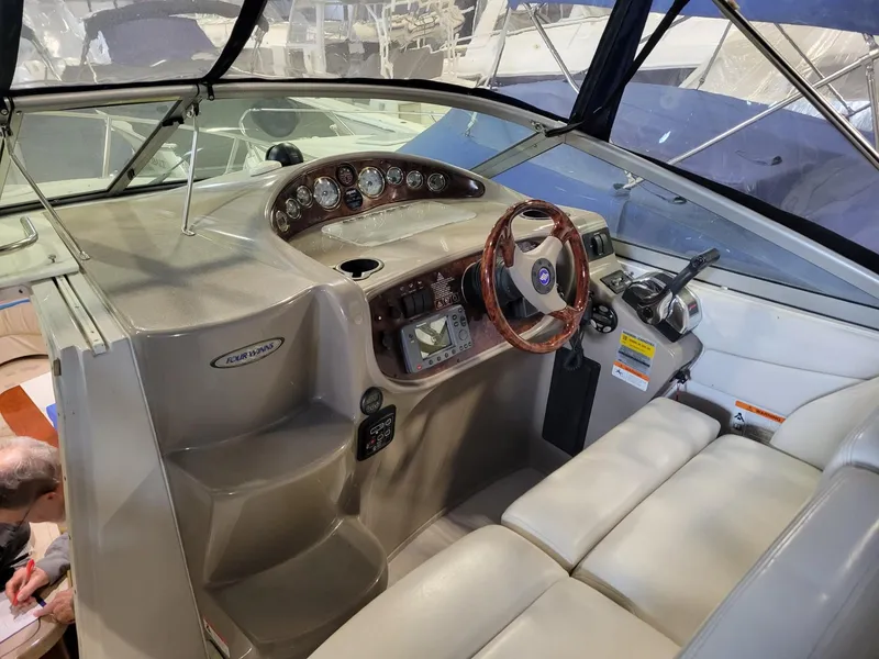 Slide: The Image of 2003 Four Winns 248 Vista boat cockpit with steering wheel and control panel. - 2