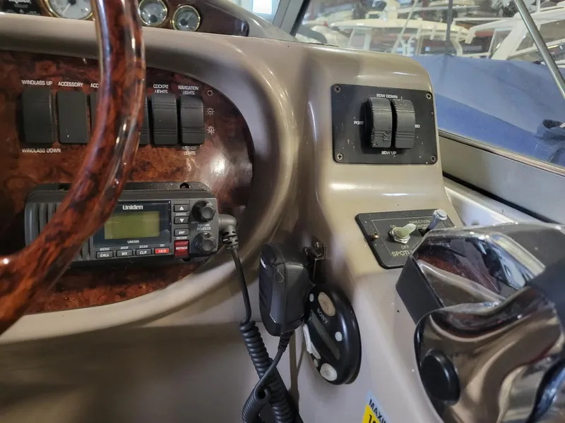 Slide: The Image of 2003 Four Winns 248 Vista boat dashboard with controls and radio equipment. - 6